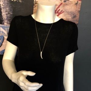 Long gold necklace with tusk.